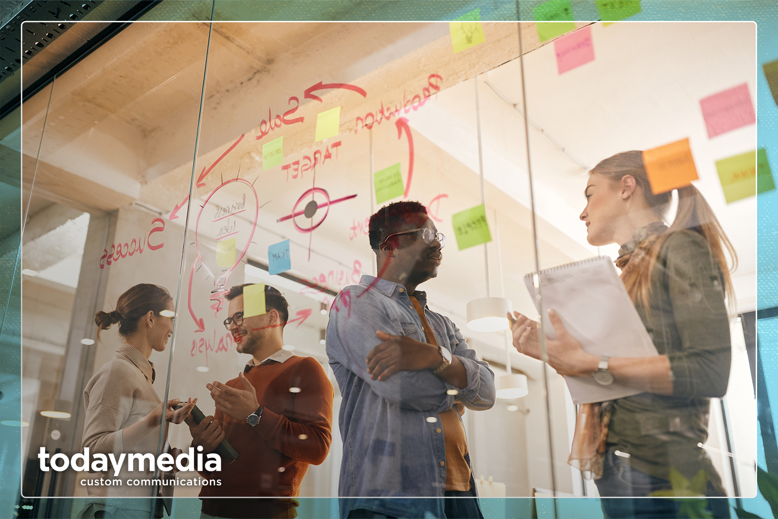 Team of multiracial entrepreneurs talk in front of mind map on glass wall in office.